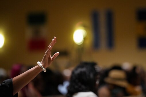 Minister Tonya Rice waves her hand in the air during prayer at Dontae Melton Jr.’s funeral at DreamLife Worship Center in Randallstown, Md. on Saturday, July 12, 2025. The 31-year-old died in police custody in June, just one day after his mother had attempted to file an emergency petition in court out of concern for his mental health.