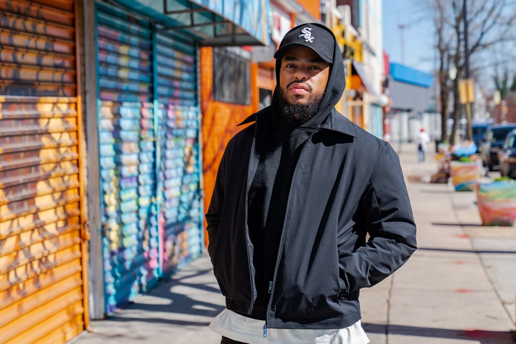Wallace Lane poses for a portrait in Park Heights, where he grew up, on Friday, March 29, 2024.
