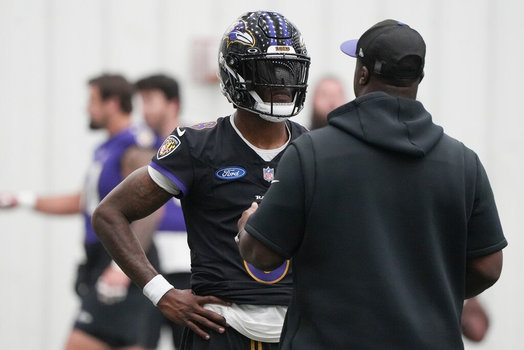 Baltimore Ravens quarterback Lamar Jackson (8) listens to quarterbacks coach Tee Martin during the team’s mandatory minicamp at the Under Armour Performance Center in Owings Mills, Md. on Wednesday, June 18, 2025.