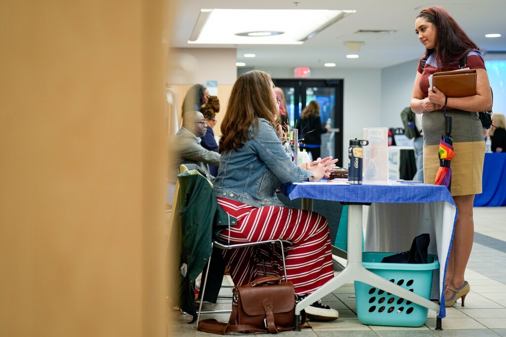 Tatyana Padro Miguel, right, speaks with representatives at Brighter Strides during a Healthcare Employer career fair at Anne Arundel Community College in Arnold, Md. on Wednesday, May 21, 2025.