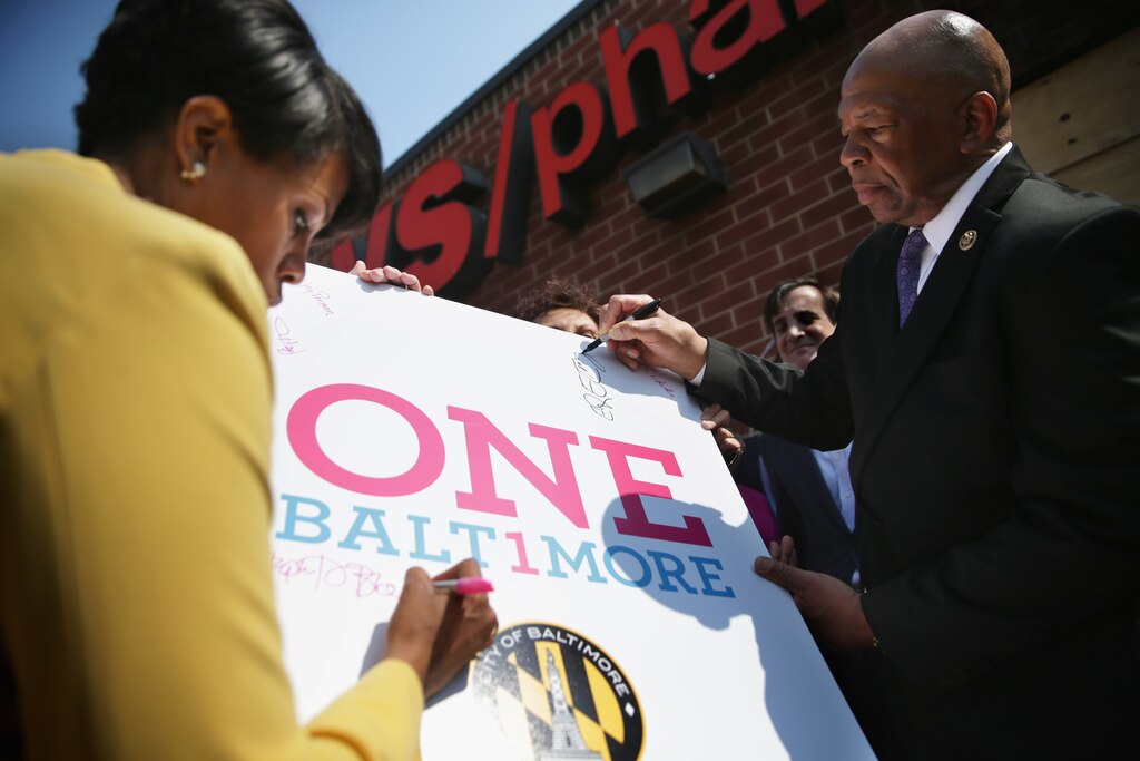 BALTIMORE, MD - MAY 07: Mayor Stephanie Rawlings-Blake (L) and U.S. Rep. Elijah Cummings (D-MD) (R) sign a poster during a news conference in front of the burned CVS in the Sandtown neighborhood May 7, 2015 in Baltimore, Maryland. Community leaders joined the mayor to kick off the One Baltimore campaign, a public-private initiative to support efforts to rebuild communities and neighborhoods after the riot that was caused by the death of Freddie Gray.
