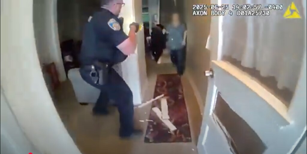 A still image from body cam footage released on Wednesday, July 9, 2025 by the Baltimore Police Department, shows police after breaking down the front door and entering the home of 70-year-old Pytorcarcha Brooks.
