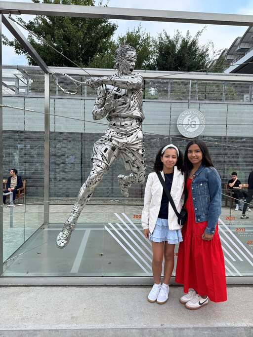 Arden Antalics, left, and sister Averlin stand in front of Roland Garros Stadium in Paris ahead of seeing American tennis player Coco Gauff win the French Open in June.