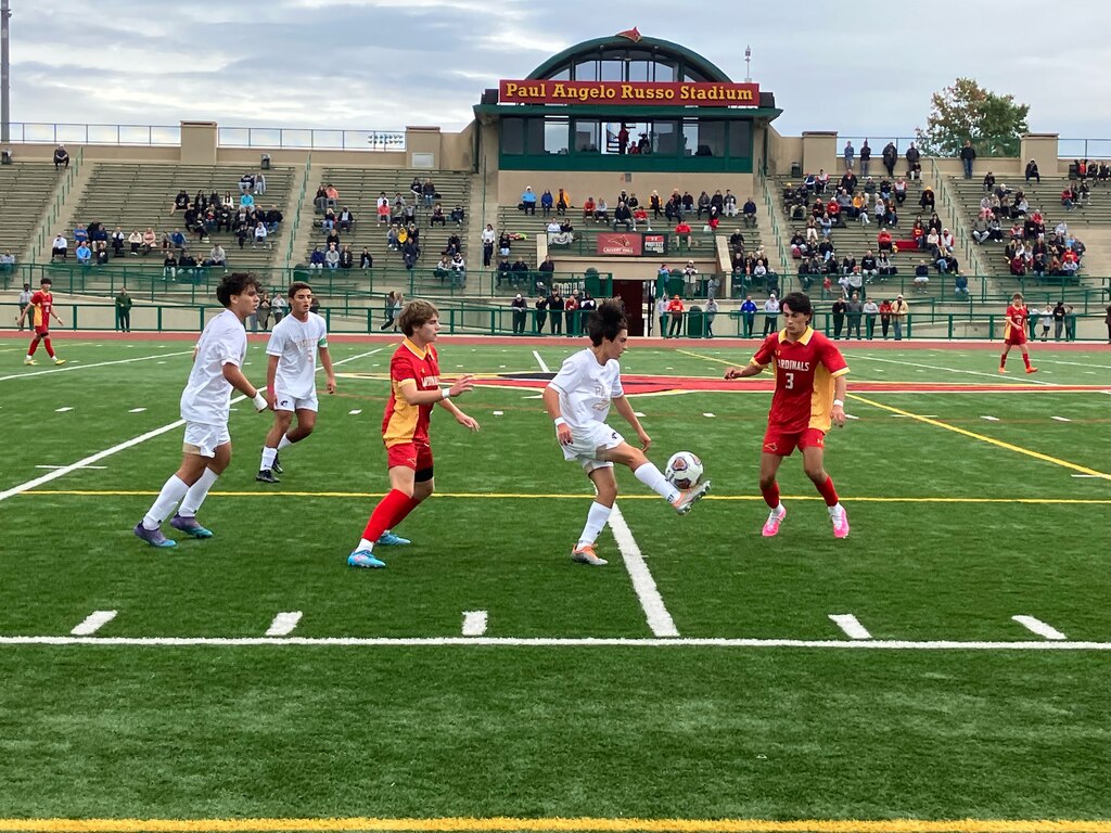 John Carroll senior Luke Meija is surrounded by Calvert Hall’s Ben Madore (left) and Rocco Pastore in an MIAA A Conference match on Wednesday in Towson won by the No. 1 Cardinals, 5-1.