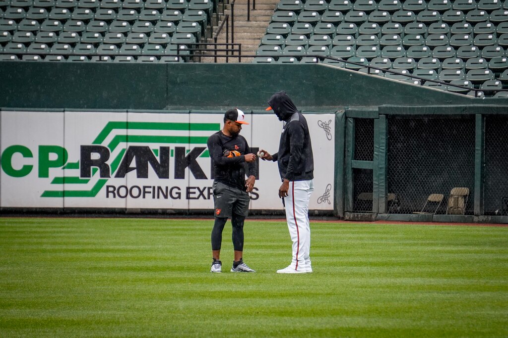 Orioles closer Félix Bautista demonstrates a pitch grip to fellow reliever Yaramil Hiraldo on Tuesday, May 27, 2025, at Camden Yards in Baltimore.