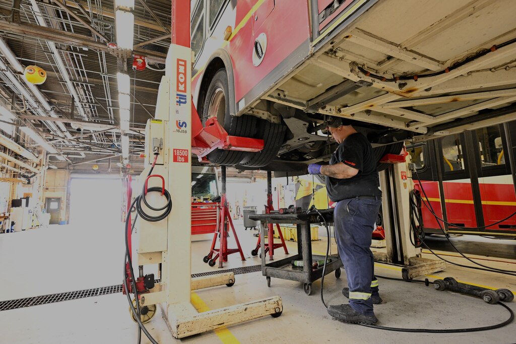 Jay Mullins works on the suspension of a bus in the maintenance shop at the MTA’s Eastern Division bus lot on Tuesday, May 6, 2025.