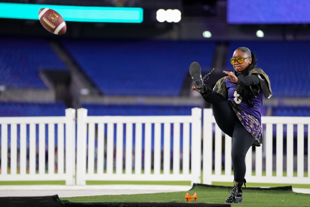 “Queen D” attempts a field goal during A Purple Evening, the Baltimore Ravens’s annual women’s event, at M&T Bank Stadium in Baltimore on Monday, October 14, 2024.