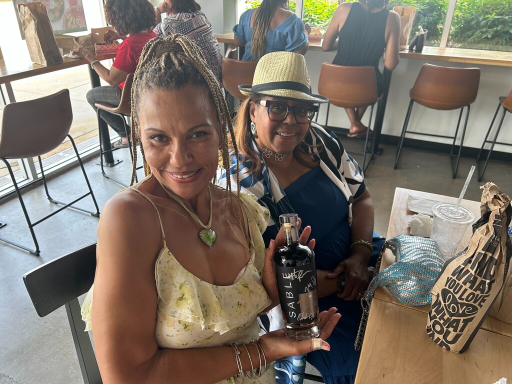 Because they were among the first 150 attendees, Cynthia Wiggins, left, and Jeannia Forrest got autographed bottles of Sable Bourbon, photos with the stars and a free meal from a nearby restaurant.