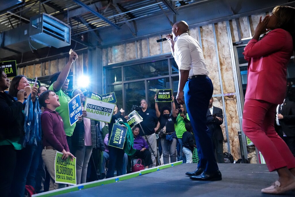 Maryland Gov. Wes Moore, middle, and his wife, Dawn Flythe Moore, express their support for U.S. Senate candidate Angela Alsobrooks during her Election Day-eve rally in Riverdale Park, Md. on Monday, November 4, 2024.