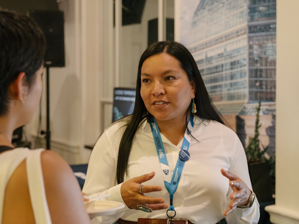 Jennifer Richards talks to an attendee the Johns Hopkins Center for Indigenous Health (JHCIH) table at the Hopkins on the Hill research showcase in the Rayburn House Office Building in Washington, D.C., on June 12, 2025.