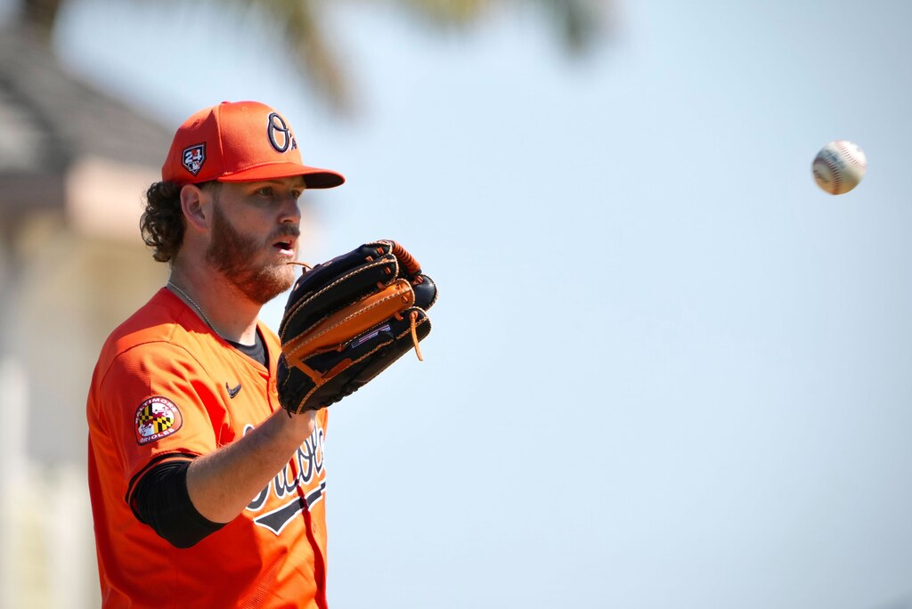 Orioles left-hander Cole Irvin catches the ball in the first inning of Baltimore's spring training game against the Pittsburgh Pirates on Sunday, Feb. 25, in Bradenton, Florida.