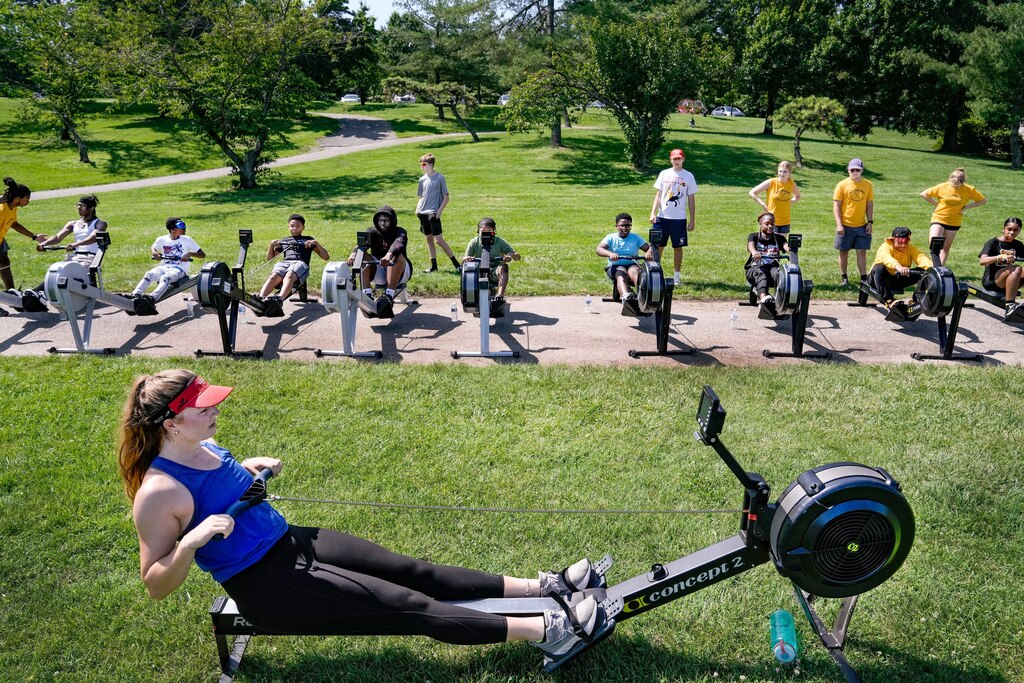 BCR coach Molly Hess demonstrates to the kids proper rowing form on the rowing machines on July 11, 2023.