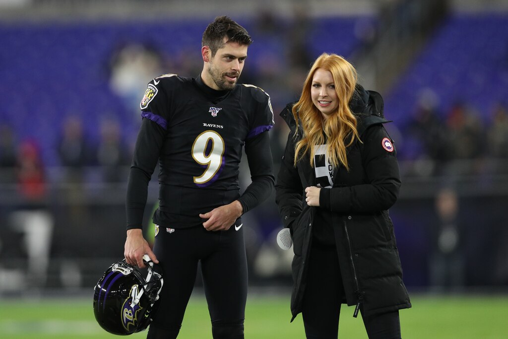 BALTIMORE, MARYLAND - DECEMBER 12: Kicker Justin Tucker #9 of the Baltimore Ravens talks to his wife, Amanda Bass, before playing against the New York Jets at M&T Bank Stadium on December 12, 2019 in Baltimore, Maryland.