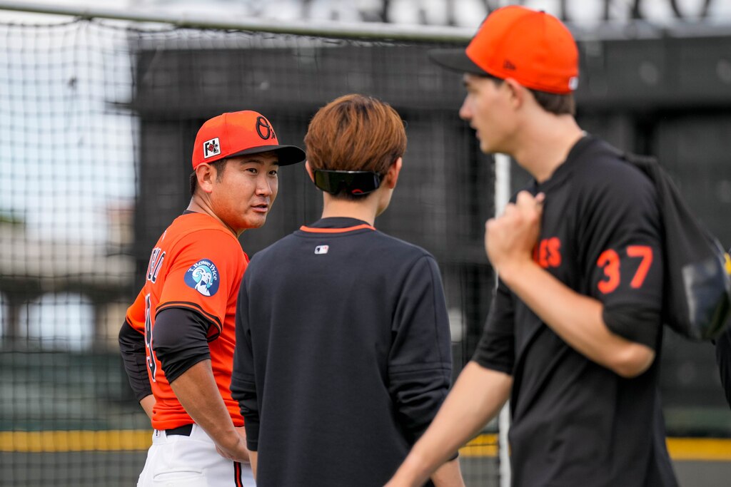 Orioles right-hander Tomoyuki Sugano speaks with his interpreter Yuto Sakurai after his first bullpen of Spring Training at the Ed Smith Stadium complex in Sarasota, Fla. on Tuesday, February 18, 2025,