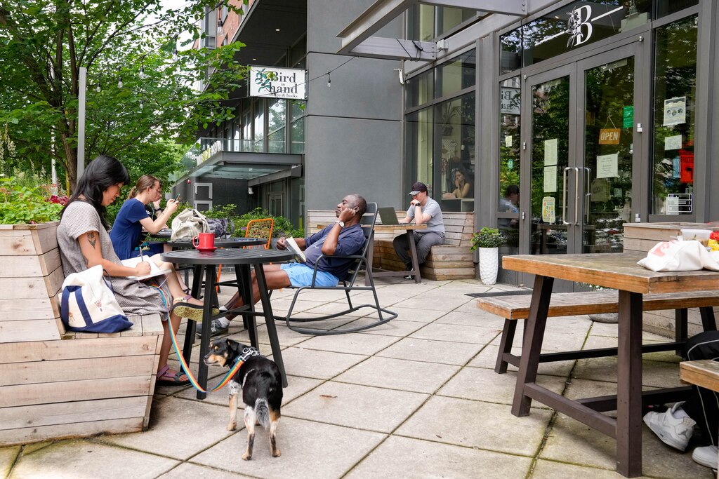 Customers work and lounge outside Bird in Hand Café and Bookstore in Baltimore, Md. on Monday, June 9, 2025.