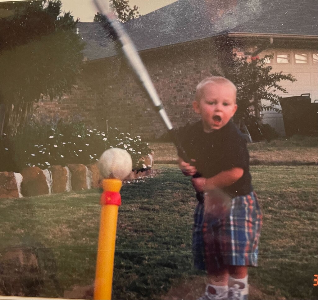 A young Jordan Westburg swings a bat that's taller than he was.