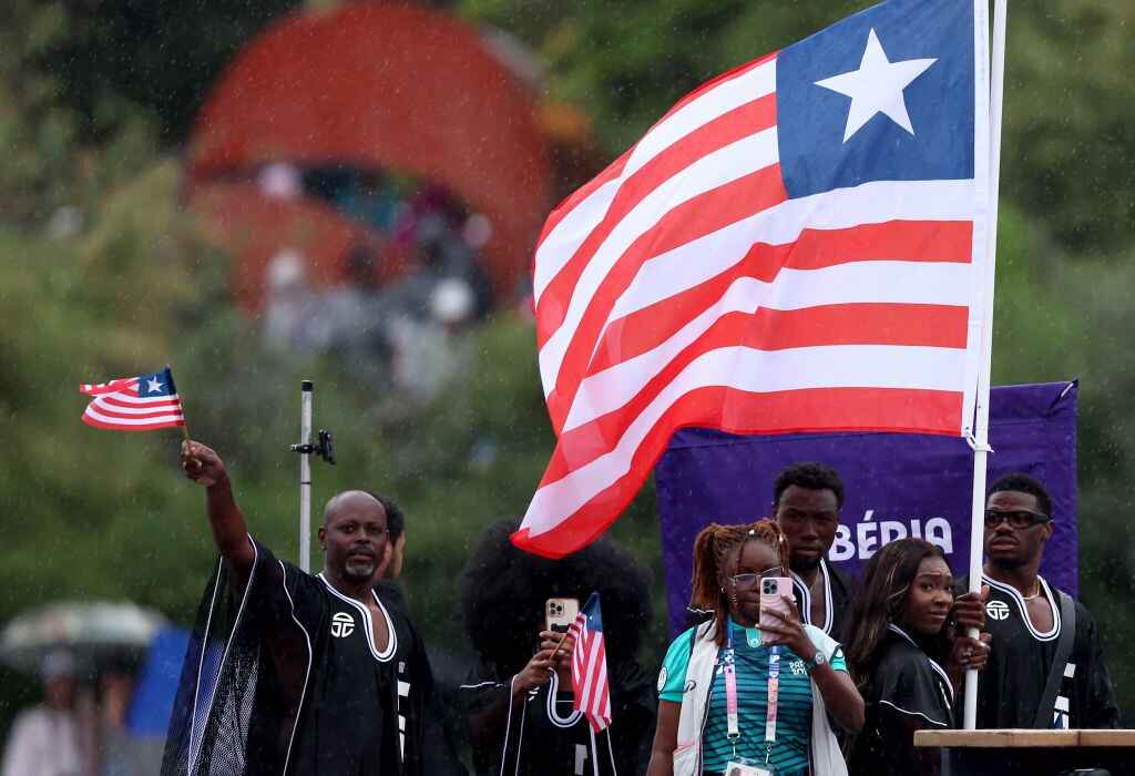 PARIS, FRANCE - JULY 26: Athletes of Team Liberia are seen on a boat on the River Seine during the opening ceremony of the Olympic Games Paris 2024 on July 26, 2024 in Paris, France. (Photo by Kevin C. Cox/Getty Images)