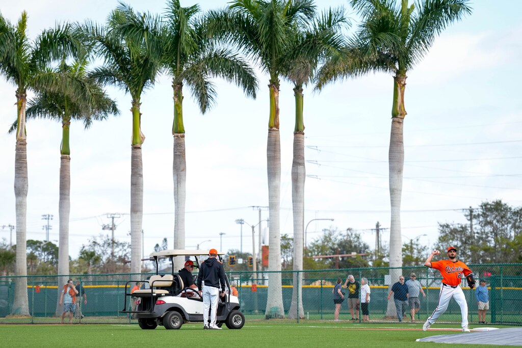 Baltimore Orioles manager Brandon Hyde speaks with pitching coach Drew French on his golf cart as pitcher Zach Eflin (24) warms up during Spring Training at Ed Smith Stadium in Sarasota, Fla. on Tuesday, February 18, 2025.