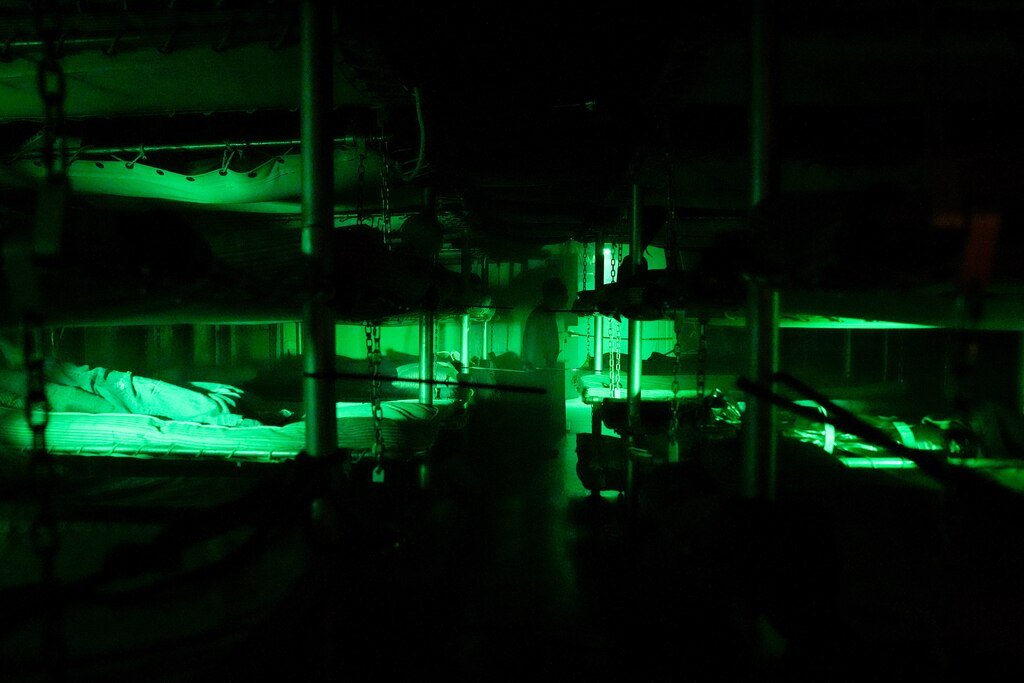 A creepy figure at the end of the hall walks off past the crew’s bunk beds during a haunted tour of the SS John W. Brown in Baltimore on Friday, October 18, 2024.