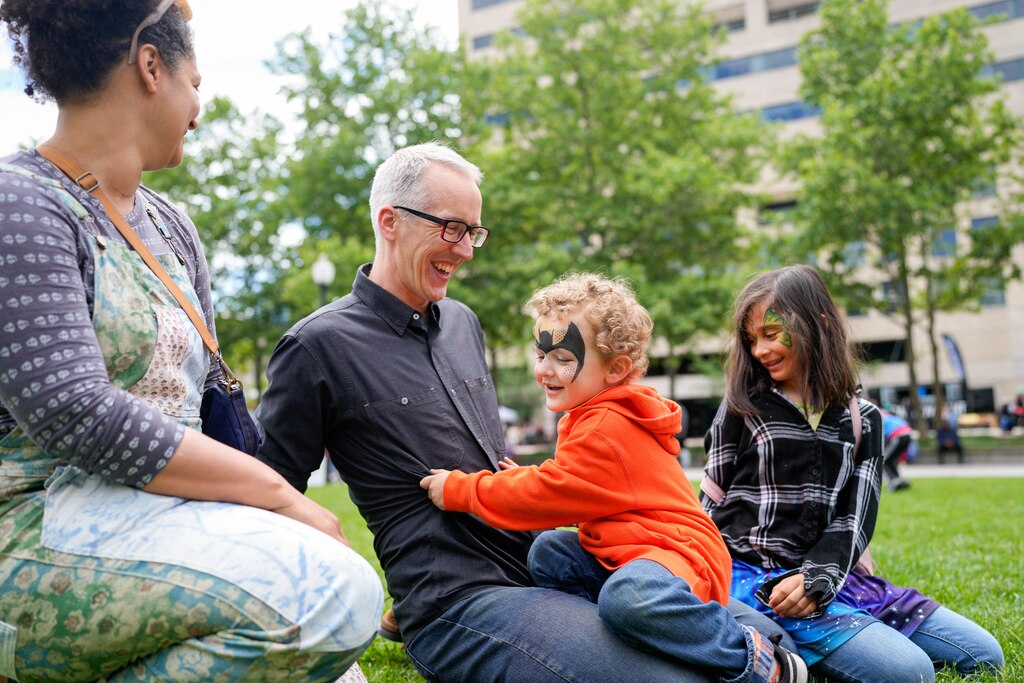 Scott Levitt, center, sits with his wife, Erin Levitt, and children George, 2, and Rosie, 8, in the plaza near the main stage at Artscape in downtown Baltimore, Md. on Saturday, May 24, 2025.