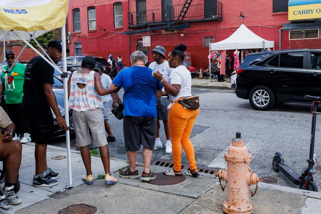 Cassandra Williams and others help a man recover from an overdose at Penn North on Friday, July 11, 2025 in Baltimore. Just a day following a mass-overdose in the area.