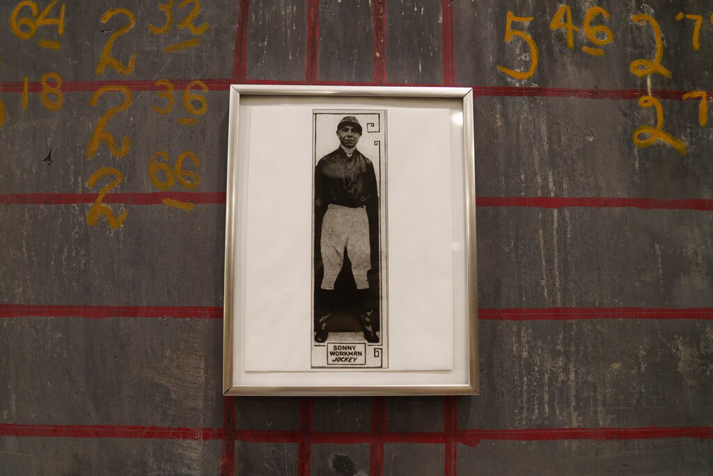 A picture of former championship winning jockey Sonny Workman hangs on the blackboard at Squire’s Italian Restaurant and Catering in Dundalk, Md. on June 30, 2025.
