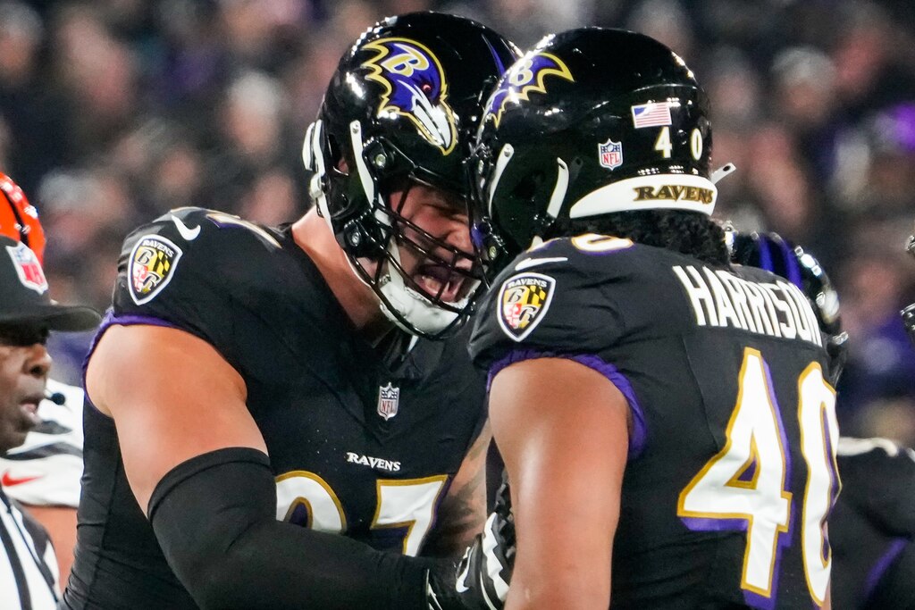 Baltimore Ravens defensive end Brent Urban (97) and Baltimore Ravens linebacker Malik Harrison (40) celebrate after tackling Cincinnati Bengals running back Joe Mixon (28) during the first quarter at M&T Bank Stadium on Thursday, Nov. 16, 2023.