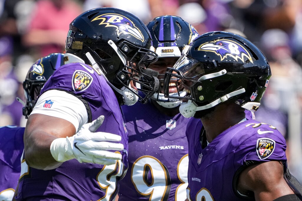 Baltimore Ravens linebacker Odafe Oweh (99), right, celebrates with defensive tackle Nnamdi Madubuike and other teammates after sacking Las Vegas Raiders quarterback Gardner Minshew during a game at M&T Bank Stadium in Baltimore on Sunday, September 15, 2024.