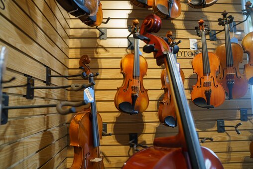 String instruments line up a corner of the Appalachian Bluegrass Shoppe in Catonsville, Baltimore County, Md. on July 2, 2025.