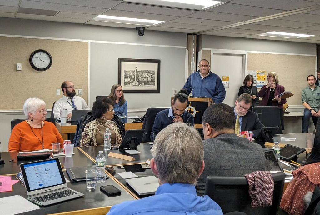 This is a photo of P. David Bramble, principal of MCB Real Estate, speaking to the Baltimore Planning Commission about the proposed redevelopment of Harborplace.