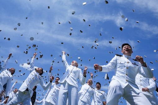 Graduating midshipmen toss their covers into the sky at the conclusion of the U.S. Naval Academy’s graduation ceremony at the Navy-Marine Corps Memorial Stadium on May 26, 2023. The graduating midshipmen are commissioned as either an ensign in the U.S. Navy or a 2nd Lieutenant in the U.S. Marine Corps.
