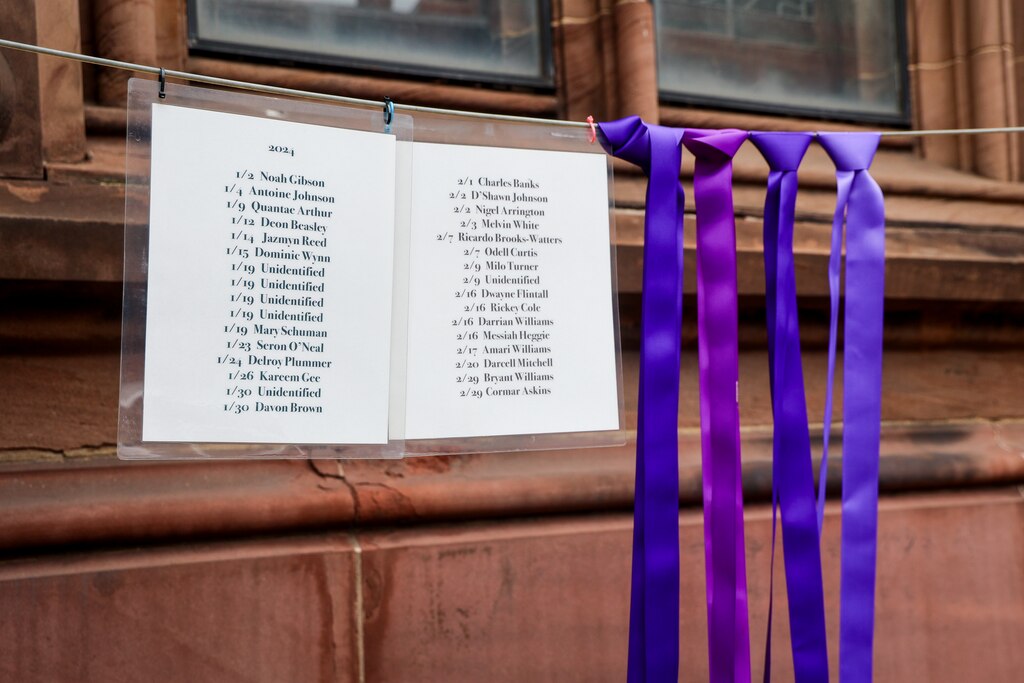 Sunday, Feb. 2, 2025 — List of names of people who lost their lives in 2024 are displayed alongside ribbons outside First and Franklin Presbyterian Church.