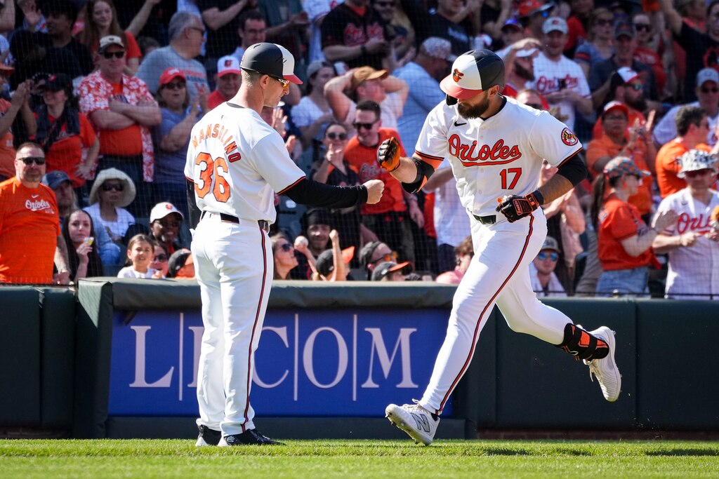 Baltimore Orioles outfielder Colton Cowser (17) celebrates with third base coach Tony Mansolino after homering during game three of a series against the Milwaukee Brewers at Camden Yards on April 14, 2024. The Orioles beat the Brewers, 6-4, to avoid getting swept in the series.