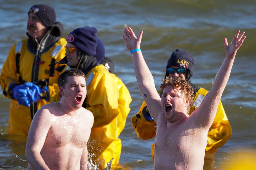 Plungers celebrate after sprinting into the freezing water at the Polar Bear Plunge on 2/4/23 at Sandy Point State Park. The event, now in its 27th year, has raised more than $3.4 million for Special Olympics Maryland this year.