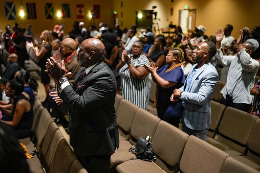 Mourners stand up and applaud as they celebrate the life of Dontae Melton Jr. during his funeral at DreamLife Worship Center in Randallstown, Md. on Saturday, July 12, 2025. The 31-year-old died in police custody in June, just one day after his mother had attempted to file an emergency petition in court out of concern for his mental health.