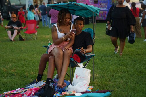 Ugochi Etuh and Unisa Bah sit together at the Cherry Hill festival in Baltimore on July 4, 2025.