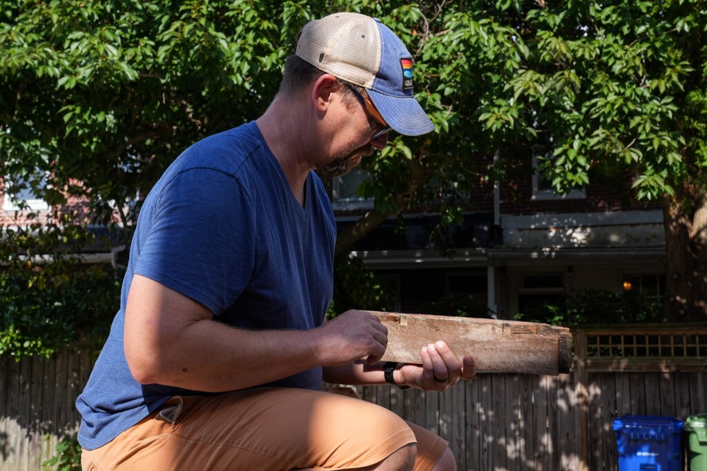 Archaeologist Dave Gadsby examines a piece of Mathilda Lorenz’s empty casket on July 28, 2022. The mysterious casket was originally found down by a stream in Wyman Park.