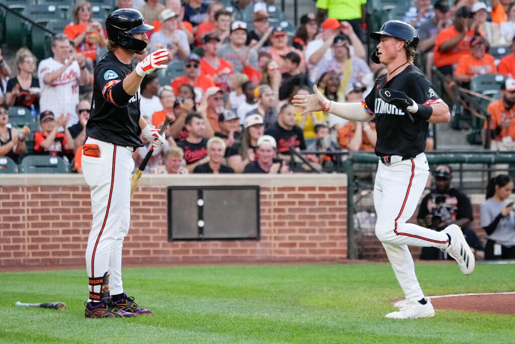 Baltimore Orioles second baseman Jackson Holliday (7) celebrates with shortstop Gunnar Henderson (2) after scoring a run in the first inning of a game against the Miami Marlins at Oriole Park at Camden Yards in Baltimore, Md. on Friday, July 11, 2025.
