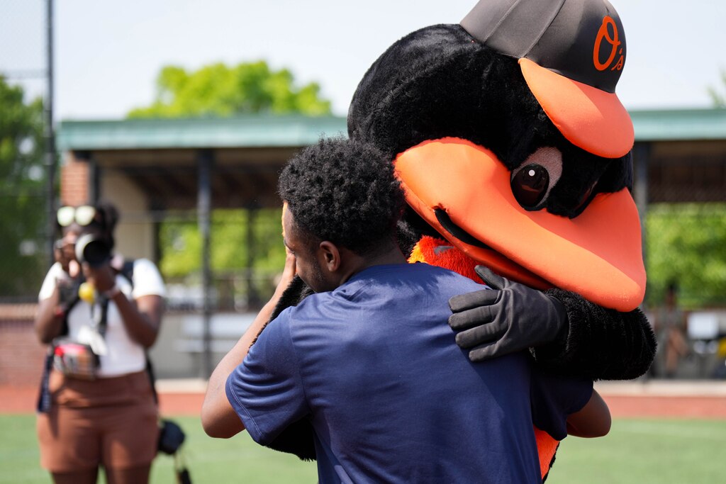 A James Mosher Baseball League player daps up the Oriole Bird during a baseball clinic at Stadium Place, former site of Baltimore Memorial Stadium, in Baltimore, Md. on Thursday, June 12, 2025. Cal Ripken Jr., along with the Cal Ripken Sr. Foundation and MLB’s Nike RBI program, launched an initiative Thursday to expand access to the sport for youth around the country.