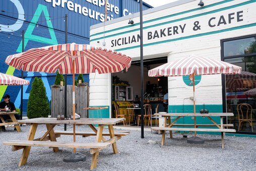 Picnic tables outside of Doppio Pasticceria in the Remington neighborhood of Baltimore, Md. on Tuesday, May 27, 2025.