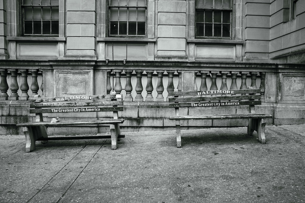 Two benches with the city slogan "Baltimore - The Greatest City in America" outside of Courthouse East.