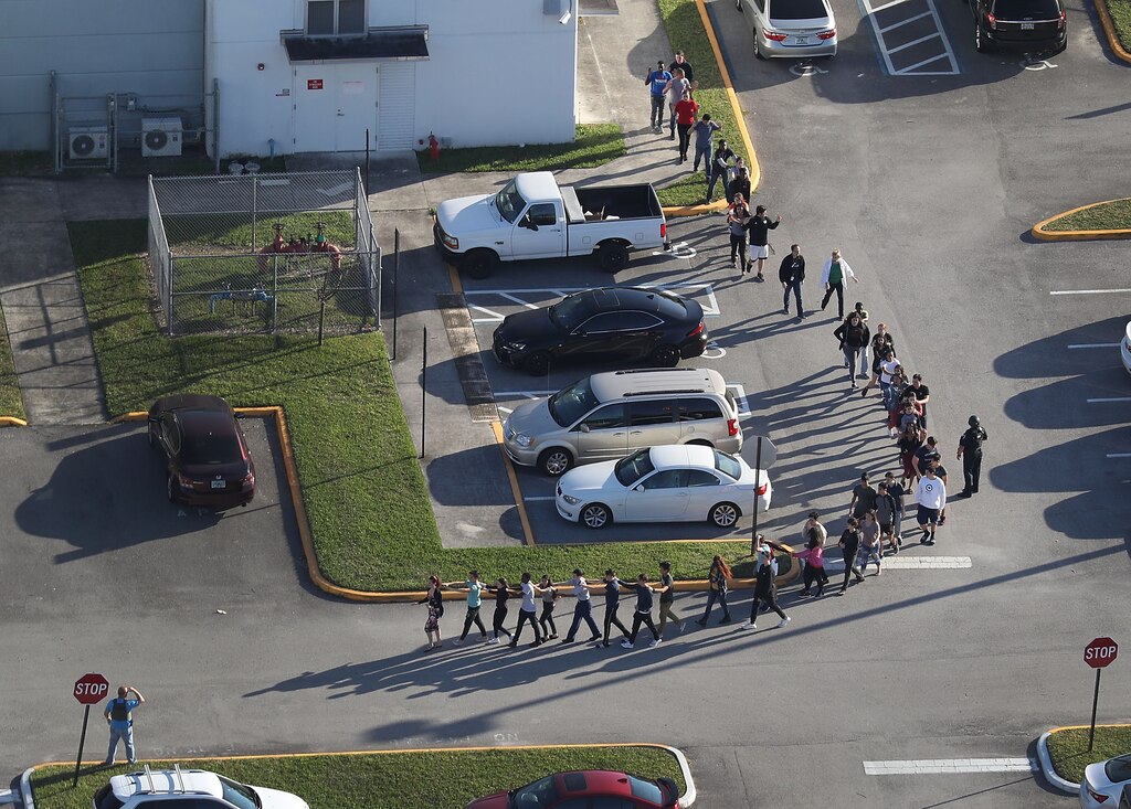 PARKLAND, FL - FEBRUARY 14: People are brought out of the Marjory Stoneman Douglas High School after a shooting at the school that reportedly killed and injured multiple people on February 14, 2018 in Parkland, Florida. Numerous law enforcement officials continue to investigate the scene. (Photo by Joe Raedle/Getty Images)