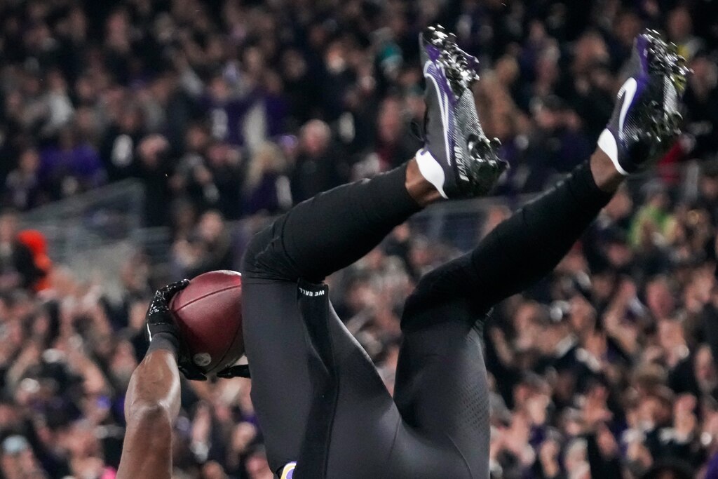 Baltimore Ravens wide receiver Nelson Agholor (15) does a flip after scoring a touchdown during the second quarter against the Cincinnati Bengals at M&T Bank Stadium on Thursday, Nov. 16, 2023.