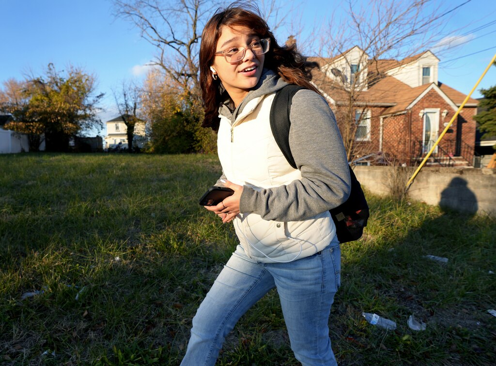 Angie Castro walks through East Baltimore in 2023. Her commute to and from school has meant she's experienced harassment several times through her high school experience.