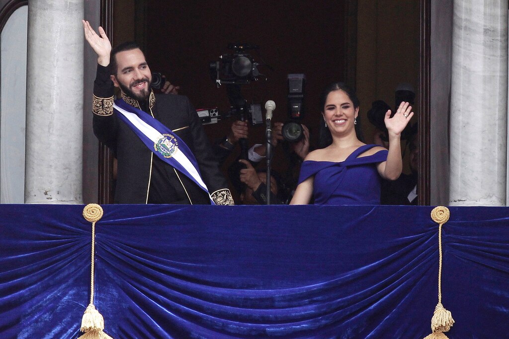 El Salvador's President Nayib Bukele and first lady Gabriela Roberta Rodríguez wave from a balcony after he was sworn in for a second term, in San Salvador, El Salvador, Saturday, June 1, 2024.