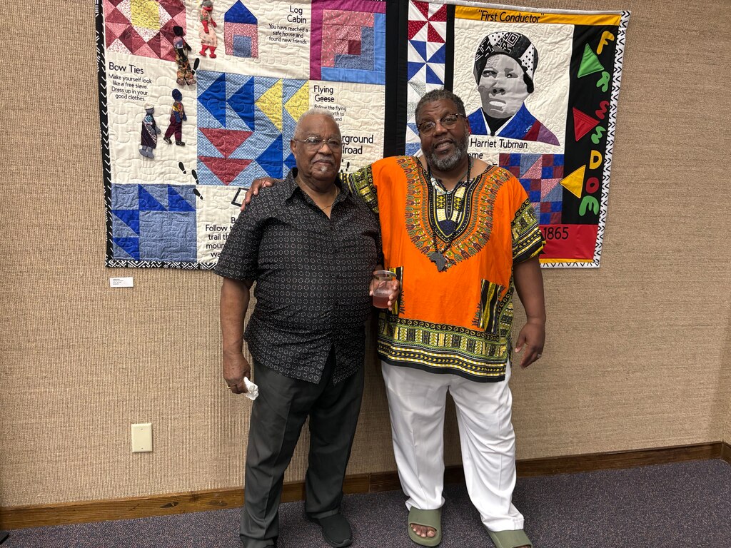 Robert Molock stands with Alex Green, who founded the Harriet Tubman Cultural Center with his wife, Lisa, and is hosting the show in Cambridge.