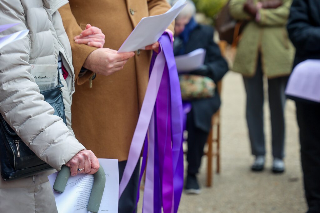Sunday, Feb. 2, 2025 — People joining arms while in prayer outside First and Franklin Presbyterian Church.