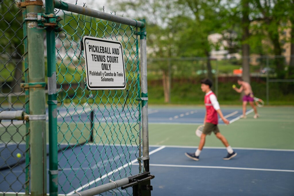 People play pickleball and tennis on courts at David Driskell Community Park in Hyattsville, Md. on Thursday, May 1, 2025.