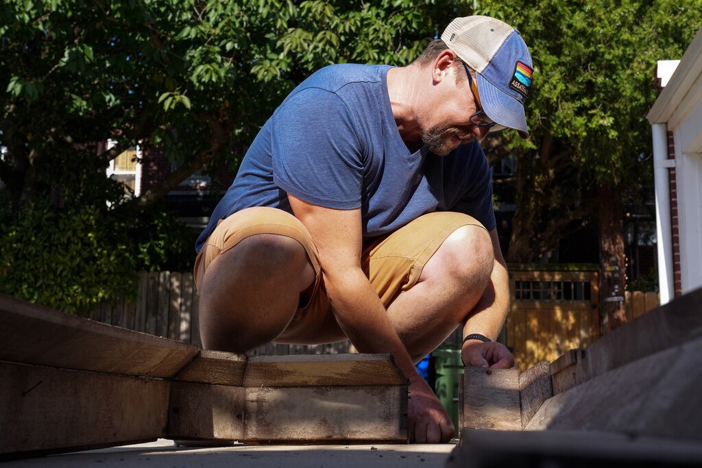 Archaeologist Dave Gadsby examines a piece of Mathilda Lorenz’s empty casket on July 28, 2022. The mysterious casket was originally found down by a stream in Wyman Park.