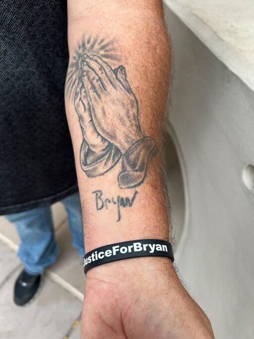 William "Scott" McKemy displays tattoo remembering his son Bryan
